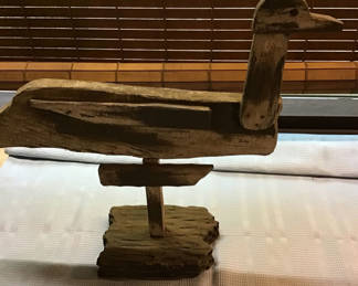 Lot 194: Rustic wooden duck sculpture on a stand