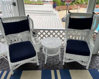 Selection of white wicker patio furniture includes these two highback chairs and matching circular side table.