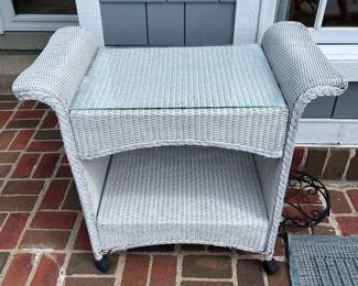 Lloyd Flanders (or similar) castered tea cart featuring a white woven frame and a glass top.