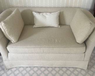 Beige linen loveseat.