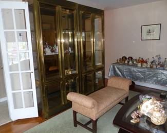 Pair of mid-century brass curio cabinets, upholstered rolled arm bench