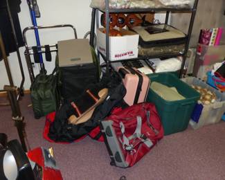 Basement with lots of assorted things including luggage