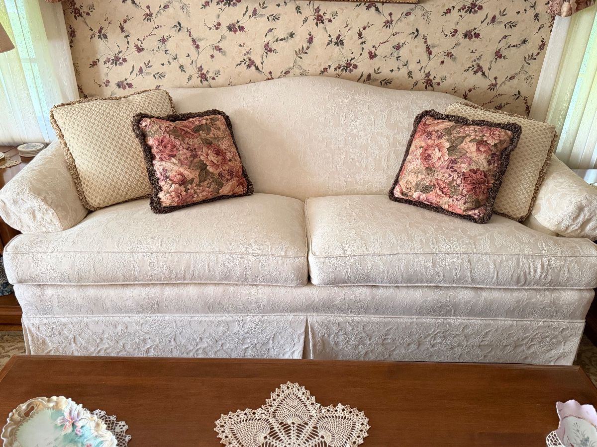 down filled cream brocade two cushion sofa 