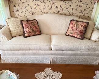 down filled cream brocade two cushion sofa 