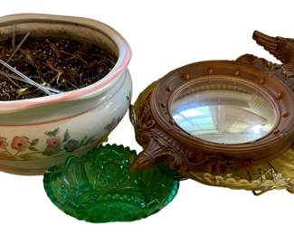 137 - Lot: Planter, Mirror, Glass Dishes (Description): A decorative lot comprising several items: a ceramic planter with pink rim and hand-painted floral design, a small ornate convex mirror with eagle finial in brown finish, a green pressed glass candy dish, and an amber cut glass serving dish with handles. Measurements not recorded.