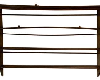 33 - Vtg Wooden Wall Display Shelf Rack 36"x51"x7" (Description): Vintage wooden wall-mounted display shelf rack featuring a dark stained finish. The piece has three horizontal shelves supported by curved side supports, designed for displaying plates, collectibles, or decorative items. Features a molded crown top and graceful bracket-style feet. Measures 36 inches wide by 51 inches tall by 7 inches deep.