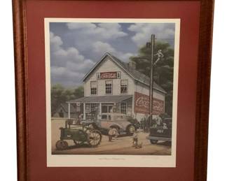 452 - Framed Signed Print Country Store Scene (Description): Framed signed limited edition print numbered 548/500, depicting a nostalgic country general store scene with vintage Coca-Cola signage. The artwork features a rural American setting with period automobiles, a John Deere tractor, and figures gathered around a white clapboard store. Presented in a wooden frame with burgundy matting. Measures 29" x 24".
