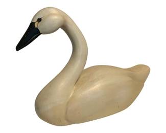 21 - Carved Wood Swan Decoy Signed 15"x22"x7 (Description): Carved wood swan decoy, signed by the artist. This hand-carved decorative swan features a gracefully curved neck, cream-white painted body, and black beak with subtle yellow accent details around the eye. The piece displays classic folk art styling with smooth, flowing lines.