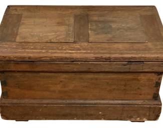 244 - Antique Wood Storage Box 15"x26.5"x15.5" (Description): Antique wood storage box featuring a paneled lid with raised border detail. The piece displays a warm, aged patina consistent with years of use, with visible wear and metal corner reinforcements on the base. The box rests on small bracket feet and features traditional dovetail or mortise-and-tenon joinery. Measures 15" x 26.5" x 15.5".