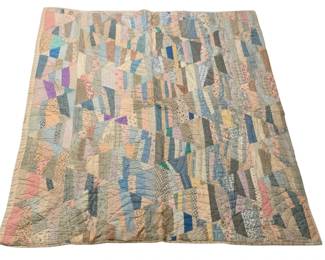521 - Vtg Patchwork Crazy Quilt 82"x60" (Description): Vintage patchwork crazy quilt featuring an eclectic arrangement of fabric scraps in various patterns, colors, and textures. The quilt showcases a traditional crazy quilt design with irregularly shaped pieces of cotton fabrics including florals, stripes, checks, and solids in soft pastel and muted tones of blue, pink, lavender, cream, and gray. Hand-quilted throughout with diagonal stitching lines. Shows signs of age and use