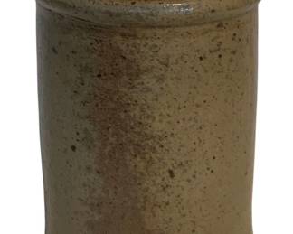 31 - Vtg Stoneware Crock 9.5"x7" (Description): Vintage stoneware crock featuring a salt-glazed exterior with a tan/beige coloration and dark brown interior glaze. The cylindrical vessel has a rolled rim and classic utilitarian form typical of American country pottery. Measures 9 1/2 inches in diameter by 7 inches tall.