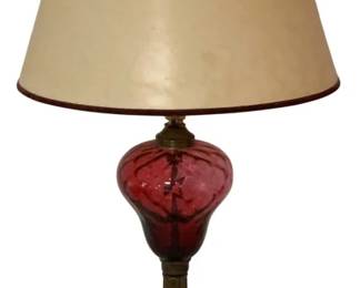 476 - Cranberry Glass Table Lamp w/ Marble Base 27" (Description): A cranberry glass table lamp featuring a swirled glass body in a rich ruby red color. The lamp is mounted on a brass column with a stepped white marble base. Includes a cream-colored fabric shade with coordinating trim. Measures 27 inches tall. Used as is electric/electronic/mechanical item. No guarantee all components, untested.