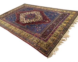 46 - Large Room Size Persian Style Area Rug (Description): Large room size area rug featuring a traditional Persian-style design with a central medallion pattern. The rug displays rich burgundy, deep blue, and cream tones with intricate floral and geometric motifs throughout. The design includes a stepped medallion center surrounded by multiple decorative borders, with a cream-colored outer border featuring botanical elements. The rug has fringed ends in a natural cream