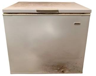 304 - Frigidaire Freezer Chest 34.5"x35"x23" (Description): Frigidaire chest freezer in white finish with lift-top lid and front drain port. Features a hinged lid with center handle for easy access. Shows wear consistent with use including some surface discoloration and minor rust near the base. Measures 34.5 inches wide by 35 inches tall by 23 inches deep. Used as is electric/electronic/mechanical item. No guarantee all components, untested.