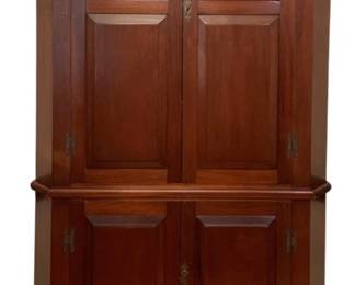 92 - Mahogany Corner Cupboard 84"x46"x24" (Description): A handsome one-piece mahogany corner cupboard in a traditional Colonial style. This stately cabinet features a dentil molded cornice above four raised panel doors with brass H-hinges and escutcheons. The upper section opens to display storage, while the lower cabinet provides additional concealed storage. The piece rests on a bracket base with shaped apron. Measures 84 inches tall by 46 inches wide by 24 inches deep.