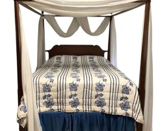 459 - Queen Poster Bed w/ Bedding 82"x88"x65" (Description): Queen poster bed with bedding. This elegant four-poster bed features tall turned posts with finial tops in a rich dark wood finish. The bed includes coordinating bedding and sheer white canopy draping. Measures 82 inches wide by 88 inches long by 65 inches tall.