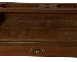 479 - Wood Desk Organizer w/ Drawer 5"x10.5"x5" (Description): Wooden desk organizer featuring multiple compartments and a pull-out drawer with decorative metal handle. The tiered design includes various sized openings on the upper level for pens, pencils, and other writing instruments, with a recessed lower tray area for additional items. The warm wood tone finish gives it a classic appearance. Measures 5 inches tall by 10.5 inches wide by 5 inches deep.