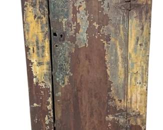 307 - Primitive Painted Wood Cabinet 58.5x25.5x14.5 (Description): Antique painted wood cabinet featuring a single door with iron hardware including hinges and a latch closure. The cabinet displays a beautifully weathered surface with layers of paint in yellow, brown, and traces of blue-green patina, revealing its age and character. The piece stands on tapered legs and offers interior storage space. Measures 58.5 inches high by 25.5 inches wide by 14.5 inches deep.
