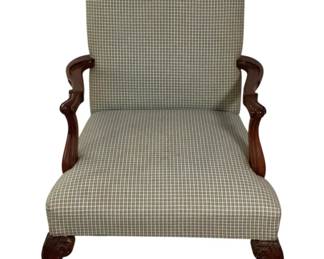 453 - Vtg Upholstered Armchair w/ Ball & Claw Feet (Description): Vintage armchair featuring a camel back design with houndstooth check upholstery in neutral tones. The chair has gracefully curved wooden arms with a rich mahogany finish and carved cabriole legs terminating in ball and claw feet. Chippendale style. Measures 37"x24"x27".