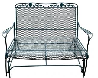 264 - Green Metal Mesh Patio Glider 34"x44"x25" (Description): Green painted metal patio glider featuring an expanded mesh seat and back. The frame is adorned with a decorative scrollwork and rose motif along the top rail. Curved arms and rocking base provide comfortable outdoor seating. Measures 34 inches high by 44 inches wide by 25 inches deep.