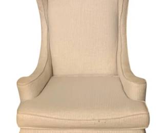 237 - Cream Upholstered Wingback Chair w/ Skirt (Description): Cream upholstered wingback chair featuring a high back with curved wings, rolled arms, and a pleated skirt base. The chair is covered in a textured ribbed fabric throughout. Measures 45 inches high by 27.5 inches wide by 28 inches deep.