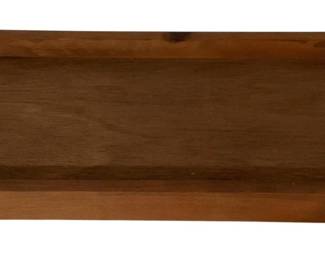 474 - Wood Serving Tray 3"x24"x12.5" (Description): Wooden serving tray with raised edges and curved cutout handles on each end. The tray features a warm medium brown finish with visible wood grain. Measures 3 inches high by 24 inches long by 12.5 inches wide.