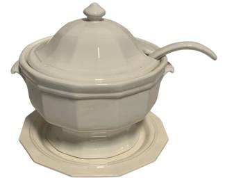71 - Pfaltzgraff White Ceramic Tureen w/ Ladle (Description): Pfaltzgraff white ceramic soup tureen with matching ladle and underplate. The tureen features an elegant octagonal shape with a domed lid topped by a finial. The set includes a coordinating underplate with matching octagonal edges. Measures 10 inches by 12 inches by 10 inches.