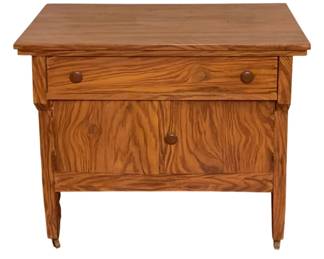 241 - Vtg Pine Wood Cabinet Stand 29.5"x34"x18" (Description): Vintage pine wood cabinet stand featuring a single drawer with two wooden knobs above a two-door cabinet with matching knob hardware. The piece displays beautiful natural wood grain throughout and rests on tapered legs with small casters. Measures 29 1/2" x 34" x 18".