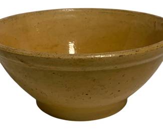 11 - Stoneware Mixing Bowl 4.5"x10" (Description): A yellow-glazed stoneware mixing bowl with a traditional footed base and rolled rim. The bowl features a warm mustard-toned glaze throughout the interior and exterior, with characteristic speckling along the rim that speaks to its handcrafted nature. Measures 4.5 inches tall by 10 inches in diameter.
