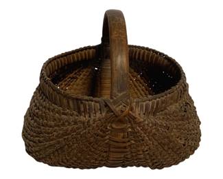 22 - Antique Woven Buttocks Basket 11"x11"x12" (Description): Antique woven buttocks basket featuring traditional splint construction with a sturdy bentwood handle. The basket displays a characteristic double-bulge or "buttocks" form created by the rib construction, with tightly woven splints in a warm brown at in a indicative of age and use. Measures 11 inches by 11 inches by 12 inches.