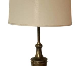 478 - Brass Trophy Urn Style Table Lamp w/ Shade 36" (Description): Brass table lamp featuring a trophy urn-shaped body with decorative acanthus leaf detailing and a fluted cylindrical base. The lamp has a traditional neoclassical design with elegant proportions and retains its original cream drum shade. Measures36 inches tall. Used as is electric/electronic/mechanical item. No guarantee all components, untested.