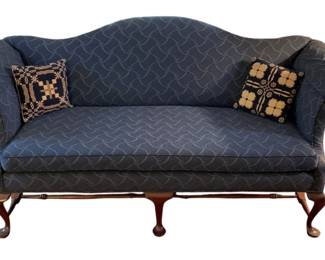 119 - Vintage Sofa w/ 2 Pillows 30"x31"x76" (Description): Vintage sofa with two decorative pillows included. The sofa features a camelback design with rolled arms and stands on carved wooden cabriole legs. Measures 30 inches high by 31 inches deep by 76 inches wide.
