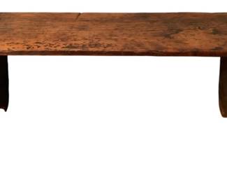 95 - Antique Wood Bench 16.5"x41"x9.5" (Description): Antique wood bench featuring a rustic plank top with beautiful aged patina and natural wear. The bench is supported by two solid cutout side panel legs with arched detailing at the base. The piece displays warm reddish-brown tones and shows authentic signs of age and use throughout. Measures 16.5" high x 41" wide x 9.5" deep.