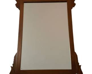 461 - Vintage Chippendale Style Mahogany Wall Mirror (Description): Chippendale style wall mirror featuring a shaped mahogany frame with scrolled fretwork details at the crest and base. The frame displays figured wood grain with a warm brown finish. Measures 25.5 inches wide by 45 inches tall.