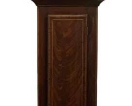 108 - Geo Brown Airdrie Grandfather Clock (Description): Geo Brown Airdrie grandfather clock featuring a mahogany case with attractive figured veneer and contrasting inlay banding. The painted dial displays Roman numerals with an arched top section decorated with figural scenes. The case includes a long trunk door with book-matched veneer panels and a shaped bracket base. Measures 82"x20"x10". Used as is electric/electronic/mechanical item. No guarantee all components, untested.