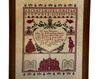 32 - Framed Needlepoint Virginia Sampler 17.5"x13" (Description): Framed needlepoint sampler featuring a Virginia theme. The piece displays a full alphabet and numbers 1-0 at the top, with decorative borders of strawberries and floral motifs. The central design includes a verse about being a Virginian, flanked by colonial-era figures of a woman in a full dress and a gentleman. The lower portion depicts a Georgian-style mansion with weeping willow trees on either side. Worked in deep