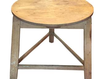 102 - Rustic Cricket Wood Table 28.5"x29.5" (Description): Rustic Cricket wood table featuring a round plank top with natural wood finish and a three-legged base with triangular stretcher support. The base retains traces of old painted finish showing charming wear consistent with age and use. Measures 28.5inches in diameter and 29.5 inches in height.