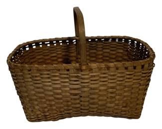 35 - Antique Woven Splint Market Basket (Description): Antique woven splint market basket featuring a bent wood handle and traditional rectangular form. The basket displays a classic splint weave pattern with natural wood coloring that has developed a warm patina with age. The sturdy construction and generous size make this an excellent example of utilitarian American basketry. Measures 10 inches by 15 inches by 10.5 inches.