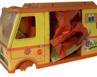 497 - Vtg Mattel Barbie Camper Van Missing Parts (Description): Vintage Mattel Barbie camper van from the 1970s, featuring a yellow body with orange accents and groovy flower decals. This classic toy shows wear consistent with age and play, with some parts missing. The camper includes the main body structure with windows, driver's cab, and roof. Measures 11"x17"x9".
