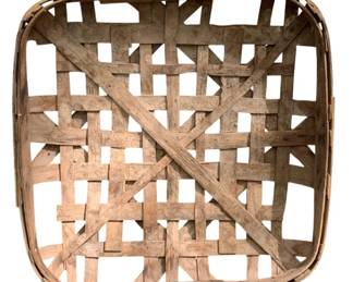 261 - Danville VA Tobacco Basket 44"x40" (Description): Antique tobacco basket from Danville, Virginia. This large woven oak splint basket features the traditional open weave construction with crossed wooden support slats characteristic of tobacco harvesting baskets. The basket displays a warm, weathered patina consistent with authentic age and use. Measures 44 inches by 40 inches.