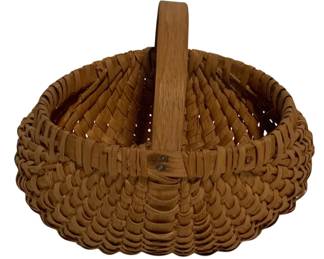 90 - Antique Woven Splint Egg Basket 7"x7"x8" (Description): Antique woven splint egg basket featuring a traditional buttocks or melon basket form with a fixed bentwood handle. The basket is constructed with natural oak or ash splints in a classic ribbed weave pattern. Measures 7 inches by 7 inches by 8 inches.