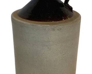 30 - Antique Two-Tone Stoneware Jug 9"x5.5" (Description): Antique stoneware jug featuring a classic two-tone design with a dark brown Albany slip glaze on the shoulder and handle, and a natural salt-glazed gray body. This traditional American pottery piece has a single loop handle and small pouring spout. Measures 9 inches tall by 5.5 inches in diameter.