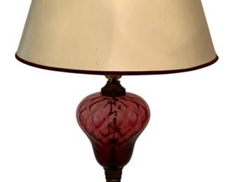 124 - Vtg Cranberry Glass & Brass Table Lamp 26" (Description): Vintage table lamp featuring a swirled cranberry glass body mounted on a fluted brass column. The lamp rests on a square white marble base with brass trim. Includes a cream fabric shade with burgundy trim. Measures 26 inches tall. Used as is electric/electronic/mechanical item. No guarantee all components, untested.