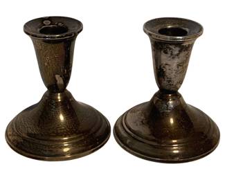 20 - 2 Sterling Weighted Candleholders (Description): A pair of sterling silver weighted candleholders featuring a classic tapered design with flared rims and round stepped bases. The set shows a rich patina consistent with age. Each candleholder measures 4 inches tall.