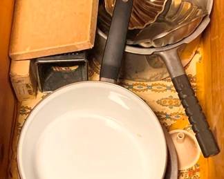54 - Drawer Lot of Assorted Items (Description): A drawer lot of assorted pots, pans, and kitchenware. The lot includes an enamel-coated saucepan with black handle, a decorative scalloped metal mold, a small metal grater or box cutter, and various other kitchen items. A useful collection of everyday cooking essentials.