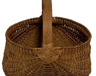 91 - Antique Woven Splint Buttocks Basket 11"x11" (Description): Antique hand-woven splint buttocks basket featuring a distinctive egg-shaped form with a sturdy bent wood handle. The basket displays traditional craftsmanship with tightly woven oak or ash splints in a classic ribbed pattern, featuring a decorative woven medallion where the handle meets the body. This utilitarian gathering basket measures 11 inches by 11 inches by 11 inches and exhibits a warm, natural patina consistent