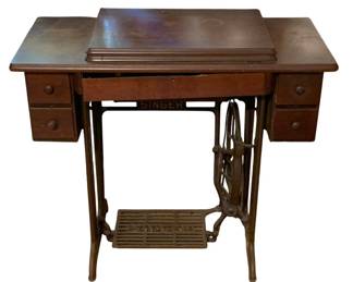 432 - Vtg Singer Treadle Sewing Machine w/ Cabinet (Description): Vintage Singer treadle sewing machine with wooden cabinet. Features a cast iron base with ornate treadle foot pedal and belt-driven wheel mechanism. The cabinet includes six small drawers with wooden knobs, three on each side. The wooden top has a hinged center section that opens to reveal the sewing machine. Measures 31" x 34" x 16". Used as is electric/electronic/mechanical item. No guarantee all components, untested.