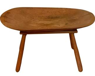 146 - Rustic Wooden Dough Bowl on Stand 18.5"x29"x1 (Description): Rustic wooden dough bowl mounted on a four-legged stand. The piece features a shallow oval carved bowl with a natural worn patina, supported by four splayed turned legs. The warm honey-toned wood shows authentic signs of age and use. Measures 18.5 x29 x 14