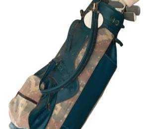 253 - Golf Clubs w/ Bag 45"x14"x10" (Description): Golf clubs with bag measuring 45 inches by 14 inches by 10 inches. The set features a teal and camouflage print golf bag with multiple pockets, carrying straps, and buckle closures. The bag contains several clubs with white head covers. The bag shows some wear consistent with use.