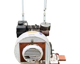 259 - Briggs & Stratton Gas Powered Blower 36"x41"x27" (Description): Briggs & Stratton gas-powered blower with wheeled cart base for easy mobility. Features a white and rust-colored housing with a large centrifugal blower unit, front vented outlet, and tubular steel push handle. Equipped with a small front caster wheel and larger rear wheels. Measures 36 inches by 41 inches by 27 inches. Shows signs of use with surface rust on metal components. Used as is electric/electronic/mechanical
